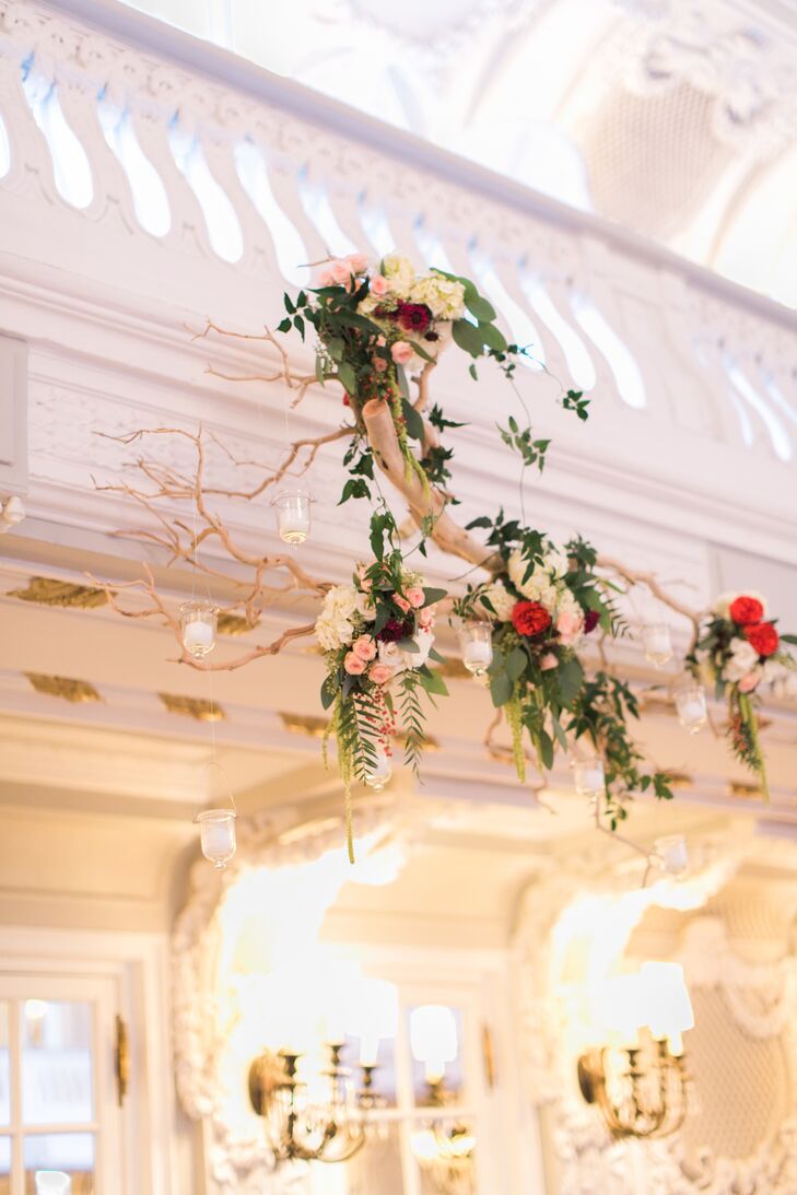A birch branch with arrangements of rose sand eucalyptus leaves hung above the guests in the gorgeous, bright reception space.