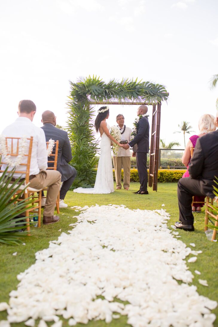 Bethany and Leonard’s intimate oceanview ceremony for 20 guests took place in the Plumeria Garden at the Four Seasons Resort Maui in Wailea, Hawaii. The aisle was strewn with white petals.