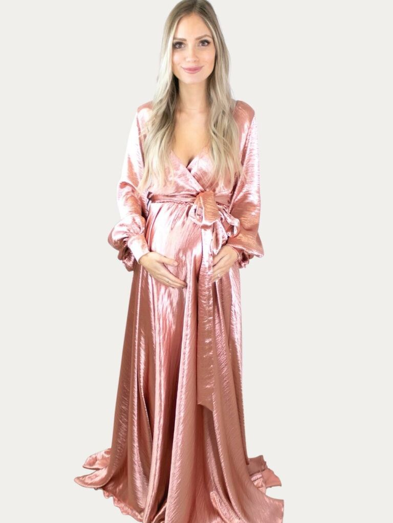 Model wears a pink shimmery maxi dress. 