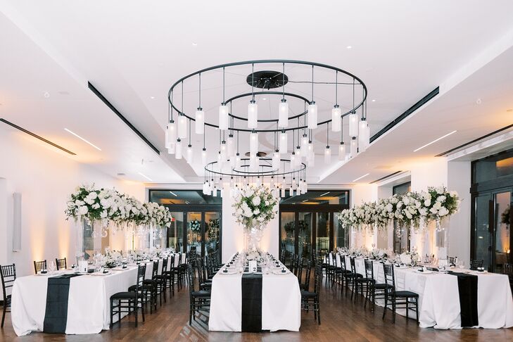 Modern Black-and-White Reception With Chandeliers and Table Runners