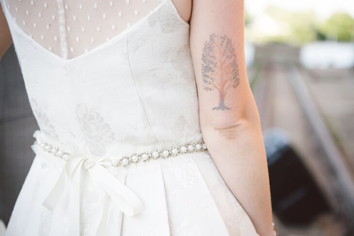 Bernice wore a one-of-a-kind tea cup style dress handmade by Made by Anatomy, a local bridal shop. The vintage-inspired dress was made of heavy floral fabric with a boat neck swiss dot sweetheart top to it. "The fabric reminded me of wall paper—I just loved it," she says.