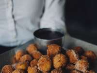 Cinnamon doughnut holes with a sugary dipping sauce