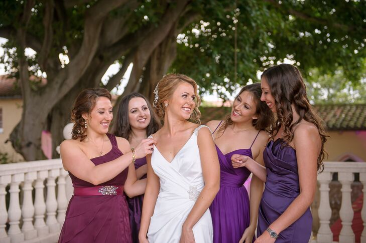 Irina and her bridesmaids took advantage of the trend for mismatched dresses. Each woman paired her down hairstyle with a plum or cranberry floor-length dress of her choosing. One matching element among them was their bouquets. Dalsimer Atlas designed  arrangements of white roses and green hydrangeas that popped against each dress.