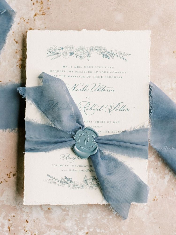 wedding invitation with blue ribbon