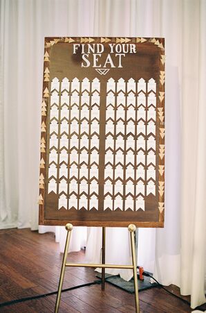 Arrow-Shaped Escort Cards on Wood Backdrop
