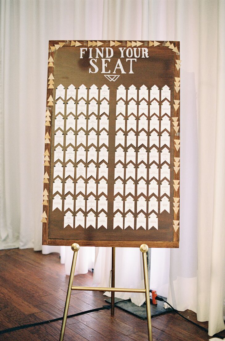 Arrow-Shaped Escort Cards on Wood Backdrop