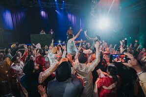 Bride and Groom Lifted Above Crowd of Chairs on the Dance Floor