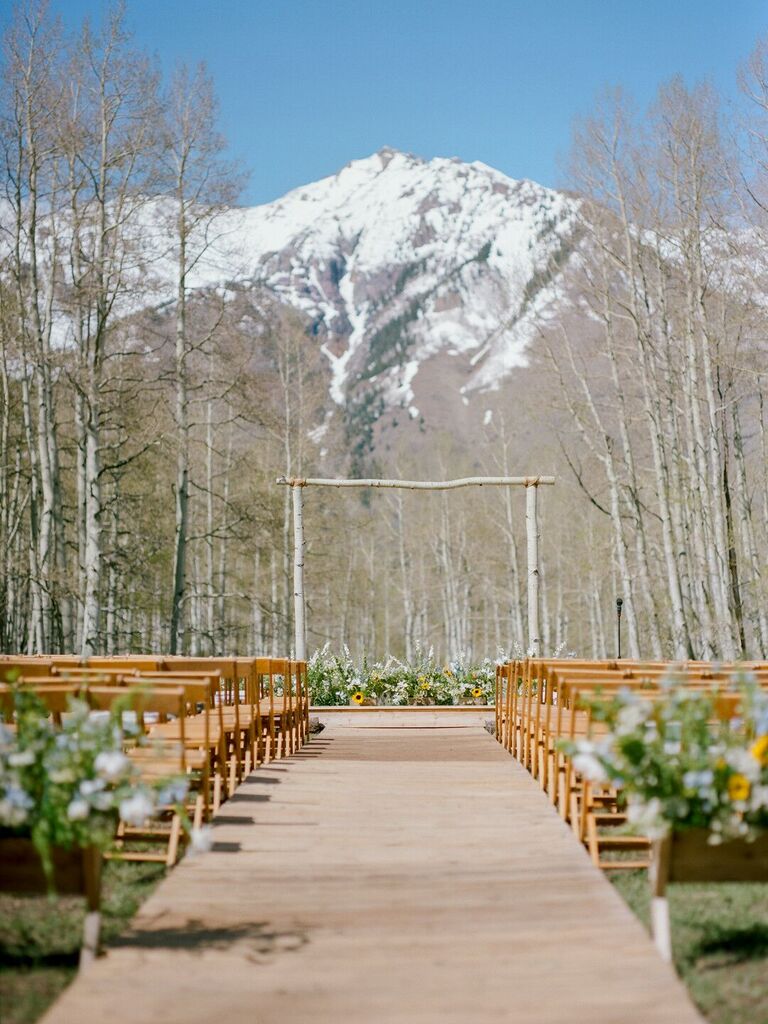 Rustic ceremony with sunflower accents and mountain backdrop