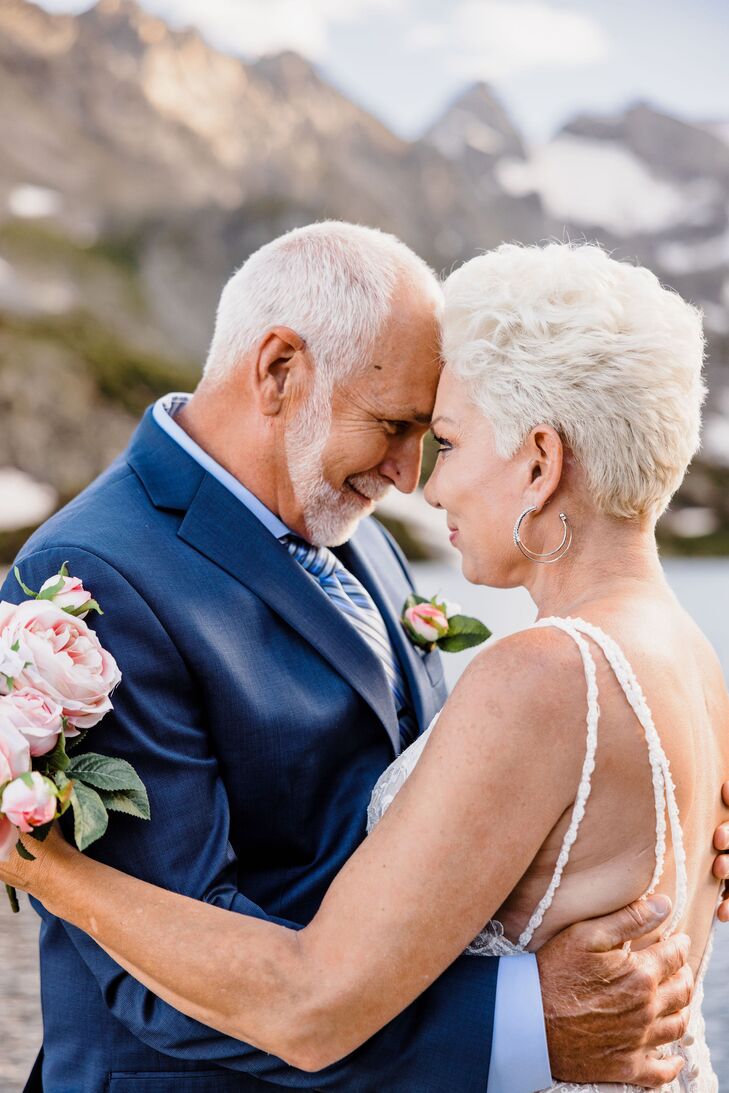 Bride and Groom Hold Each Other Close in Wedding Attire at Mountain Elopement