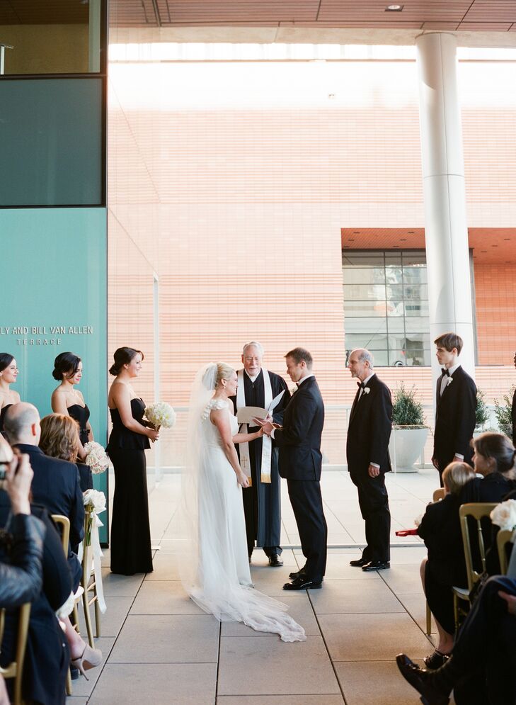 Lynn always knew she wanted to get married in Charlotte, North Carolina, since it's her hometown. But wanted something modern and sophisticated, not a traditional Southern wedding. The Mint Museum Uptown was perfect with its mostly white space and stunning views of uptown. When she went to visit the space, she was intrigued by the covered balcony on the first floor and decided to use it for the ceremony.
