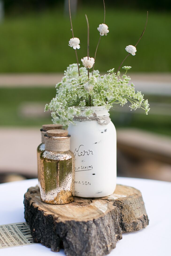 Mason jars were painted white and filled with wildflowers to create these rustic, DIY centerpieces.