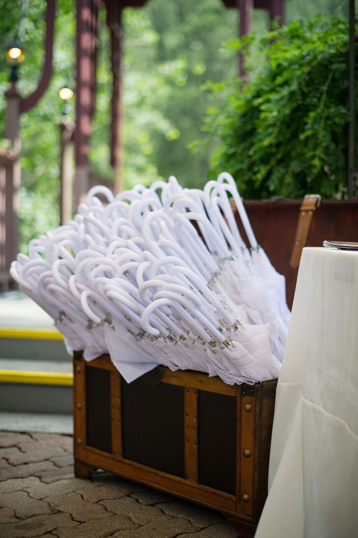 To protect their guests from scattered showers, Ashley and Kyle provided white umbrellas for the outdoor ceremony.