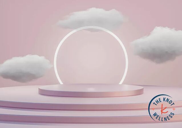 the knot mental wellness custom image with glowing white circle surrounded by clouds on a blush pink backdrop