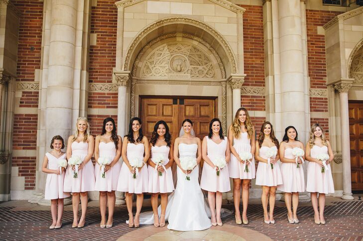 “The bridesmaids donned blush pink dresses from J.Crew, and the groomsmen wore black tuxes with light pink bow ties,” says the couple.