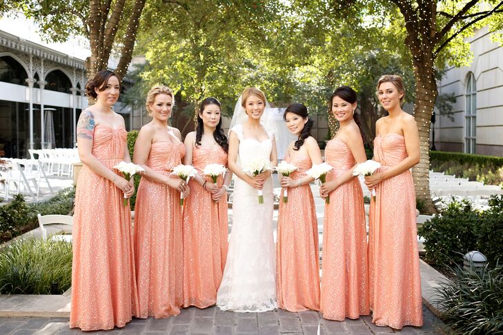 Chloe's bridesmaid dresses channeled the chic-luxe wedding style. The women wore coral pink floor-length dresses with splashes of gold and carried all-white calla lily bouquets for a modern touch.