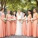 Chloe's bridesmaid dresses channeled the chic-luxe wedding style. The women wore coral pink floor-length dresses with splashes of gold and carried all-white calla lily bouquets for a modern touch.