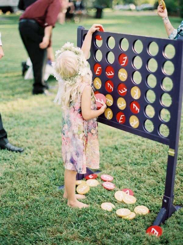 Child playing Connect Four game at a wedding