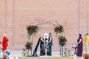 Couple Exchanging Wedding Vows in Front of Brick Wall