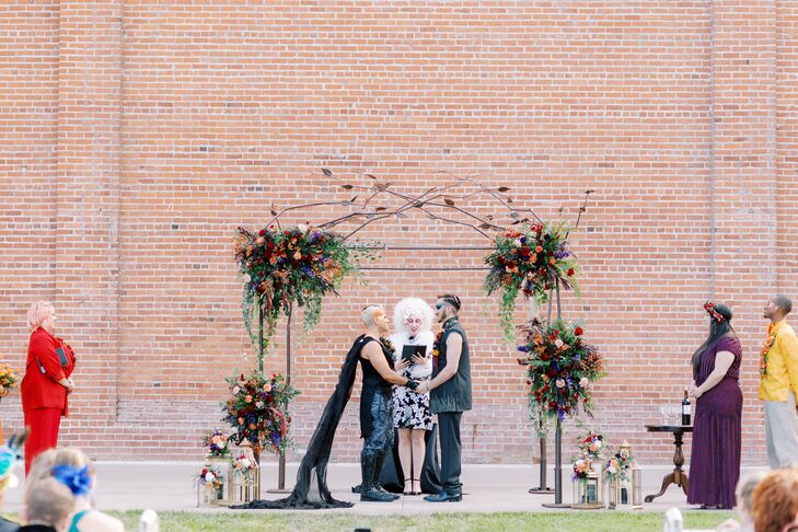 Jonathon (left) and Kyle did the seven blessings and breaking of the glass under an iron chuppah during their ceremony.