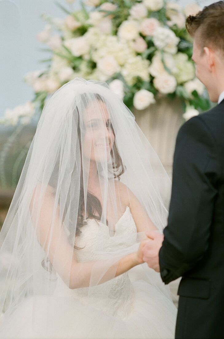 I really wanted something that was timeless and elegant, says Jessica of her veil, I also wanted something that had a really long train. I found Denise Leli, who makes custom veils and had designed Danielle Jonas's veil, which I happened to really like. She made a gorgeous veil with a cathedral length train for me, with a few added layers to give me the volume I wanted.