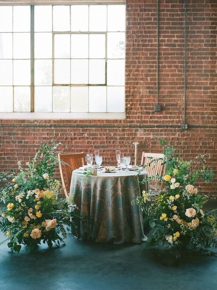 Sweetheart Table with Patterned Linens and Classic Flower Arrangements