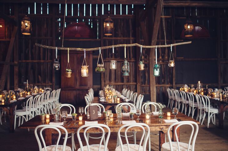 Erin and Cory's reception decor was far from typical. "I had seen a lot of wedding photos from blogs based in France and Australia and was inspired by how many beautiful garden weddings there were," says Erin. Dogwood Events lined each table with a mix of tea light candles, rustic lanterns, mason jars filled with succulents and bulb vases of baby's breath as chandeliers of the same accents were hung overhead.