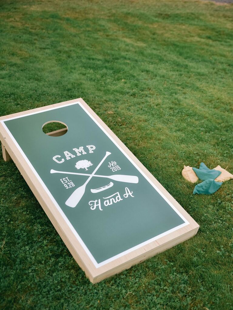 Custom cornhole boards at outdoor summer wedding