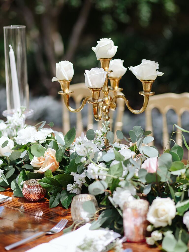 Antique gold candelabra table centerpiece with white roses
