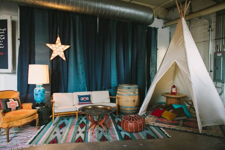 The cocktail hour and reception were decorated with large teepees, bohemian rugs, rustic wooden barrels and marquee stars to match their creative, adventure-inspired wedding theme.