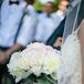 Nicole clutched an arrangement of ivory and blush blooms. The bouquet included roses, peonies and garden roses.