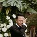 Groom in Classic Black Tuxedo Wiping Tears From His Eyes From Crying