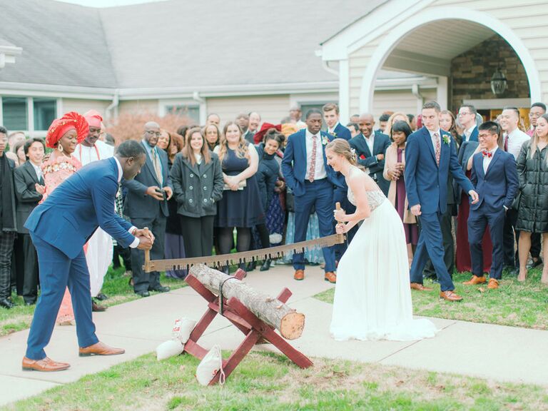 Bride and groom cutting tree stump during German log-cutting unity ceremony