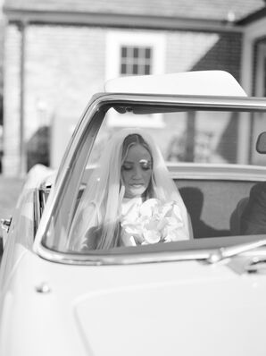 Black-and-White Photo of Bride, Veil and Small Bouquet in Passenger Seat of Classic 1968 Mercedes Car