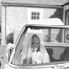 Black-and-White Photo of Bride, Veil and Small Bouquet in Passenger Seat of Classic 1968 Mercedes Car
