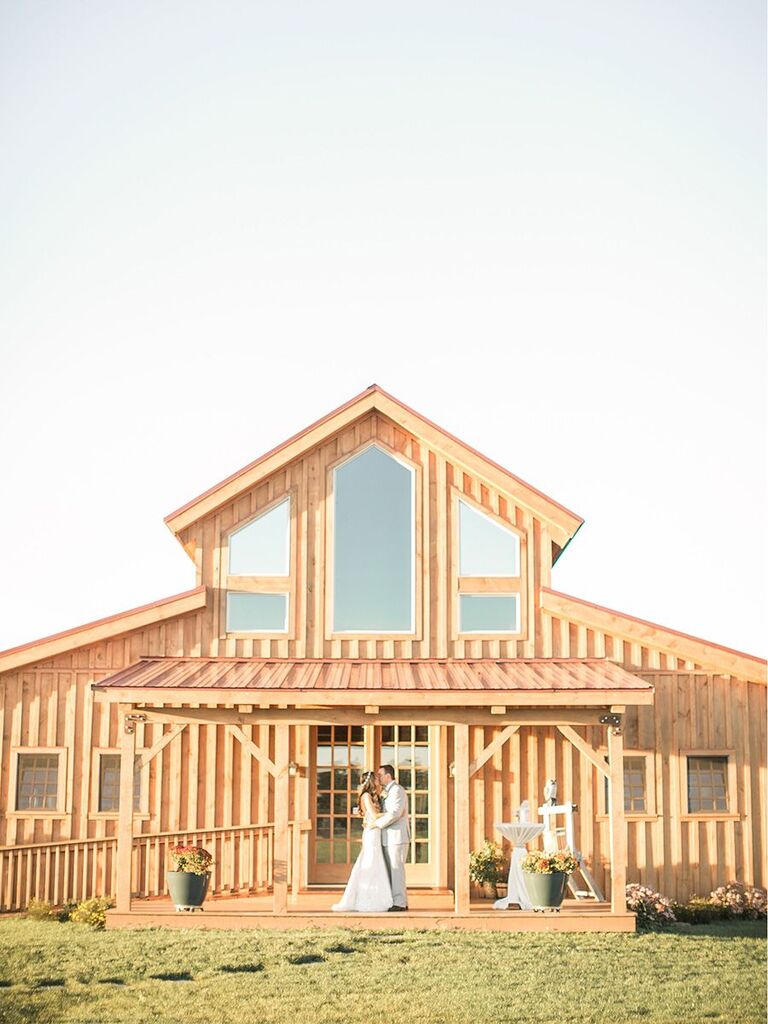 bride and groom in front of rustic modern venue