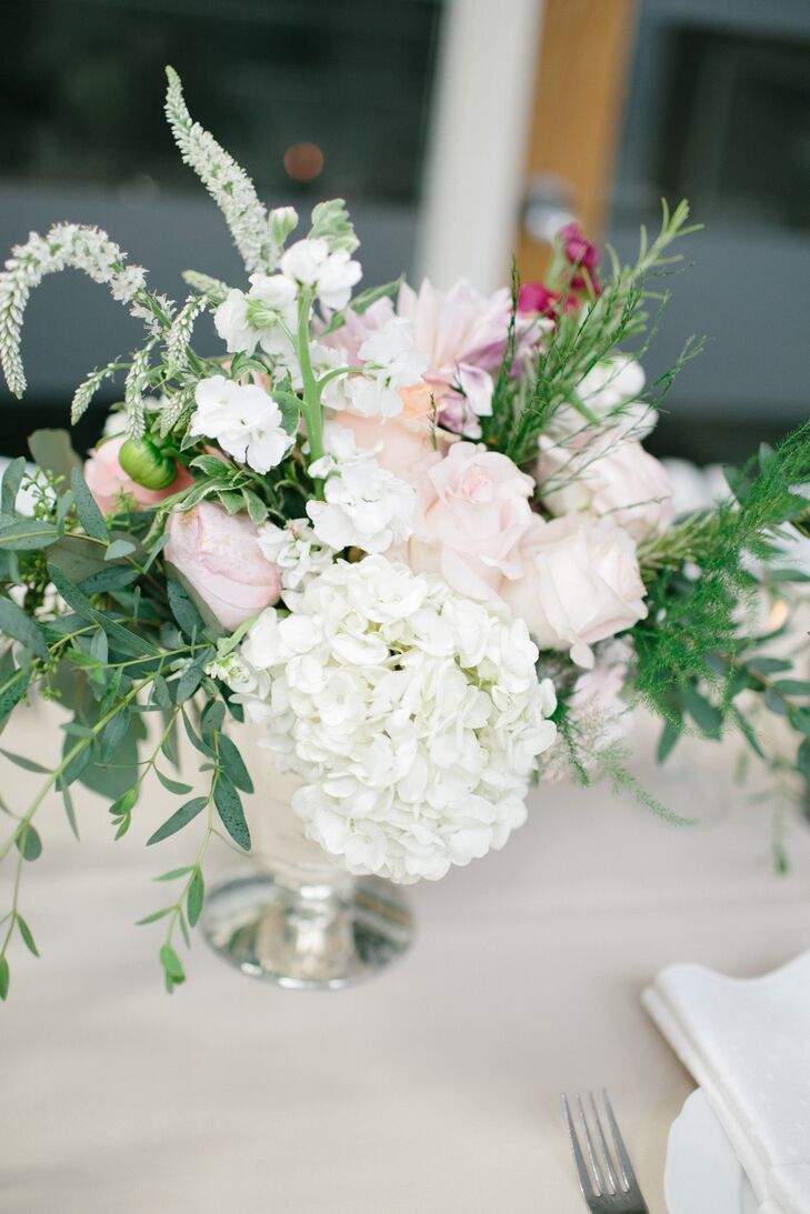 Blush roses, hydrangeas and white veronicas topped the reception tables for a rustic, botanical look that we can't help but love.