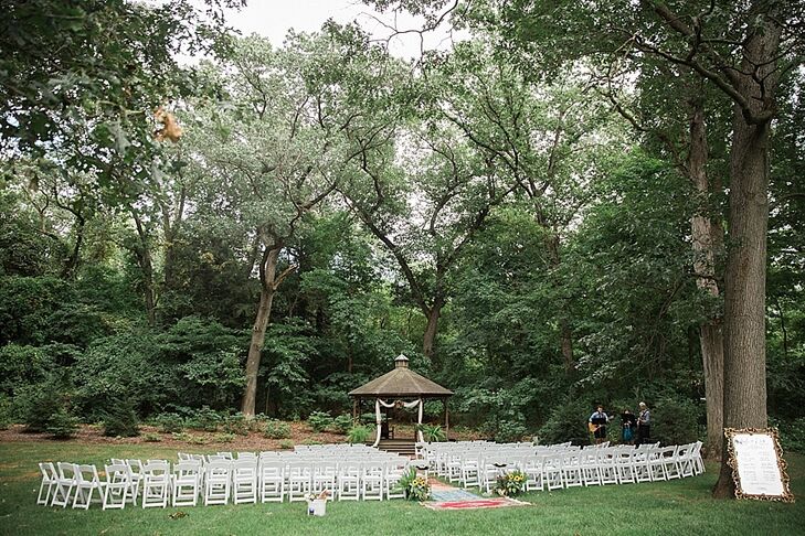 Andi and Eric exchanged vows framed by a rustic gazebo surrounded by nature.