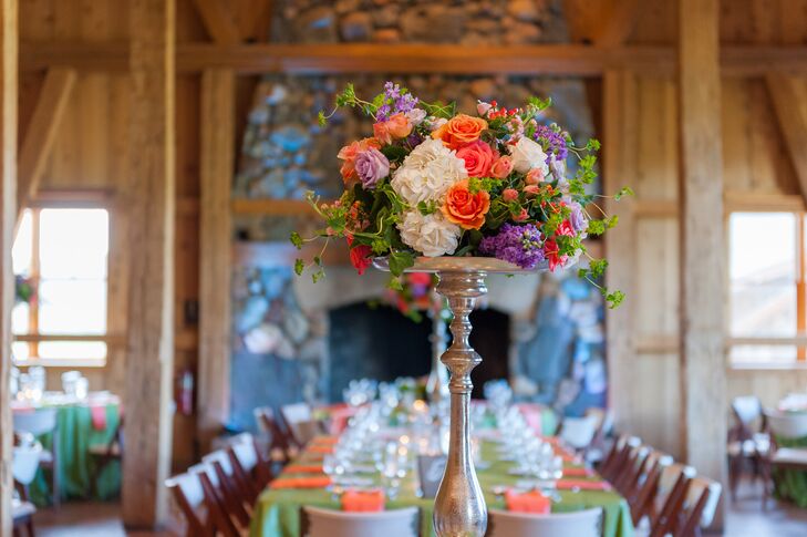 The reception tables were decorated with white hydrangeas, orange roses and purple hyacinth.