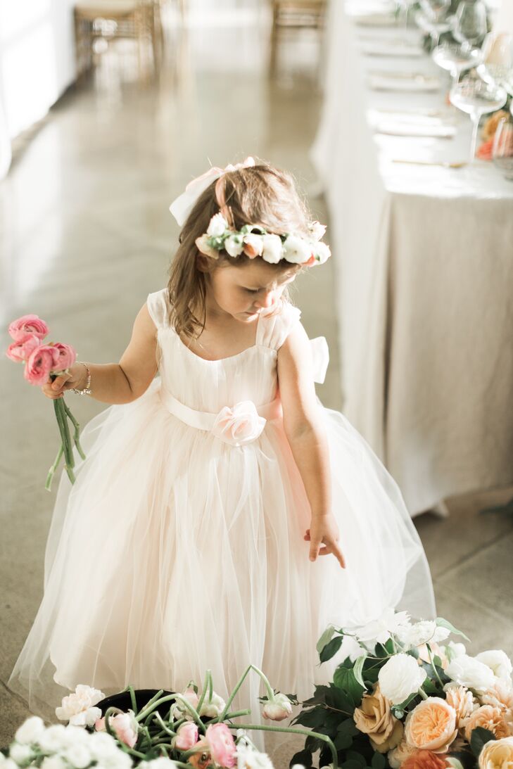 The flower girl wore a flower crown with her tulle-skirt dress.
