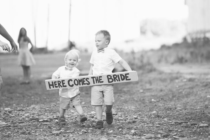 The ring bearers announced the bride with a DIY wooden sign that said "here comes the bride."