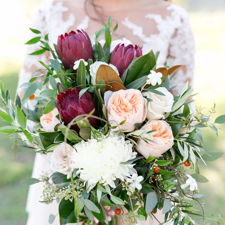 Rustic wedding bouquet with proteas and peonies