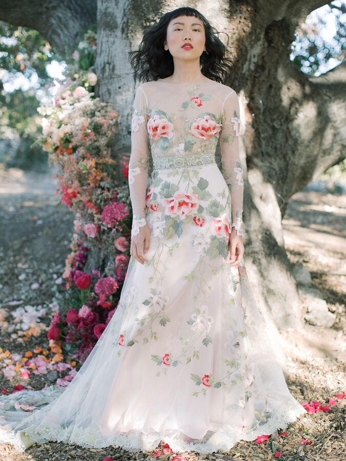 Claire Pettibone long sleeve wedding dress with pink and red flowers