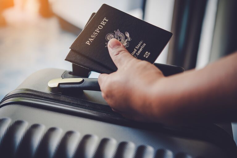 hand holding two passports for a honeymoon getaway planning