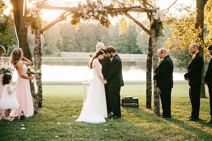 The bride and groom exchanged vows under an arbor made by the bride's father and uncle.