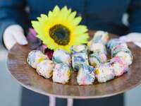 Colorful sushi rolls with sunflower accent