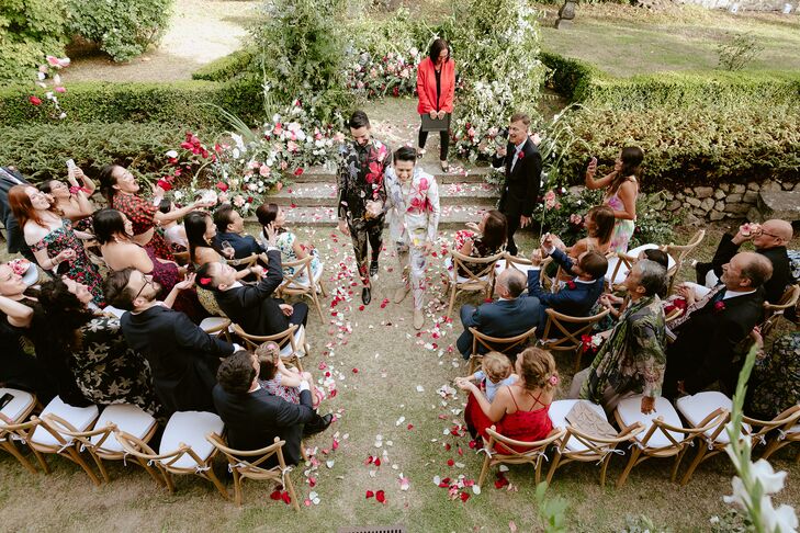 Couple Recessing Amid Cascade of Rose Petals