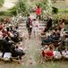 Couple Recessing Amid Cascade of Rose Petals