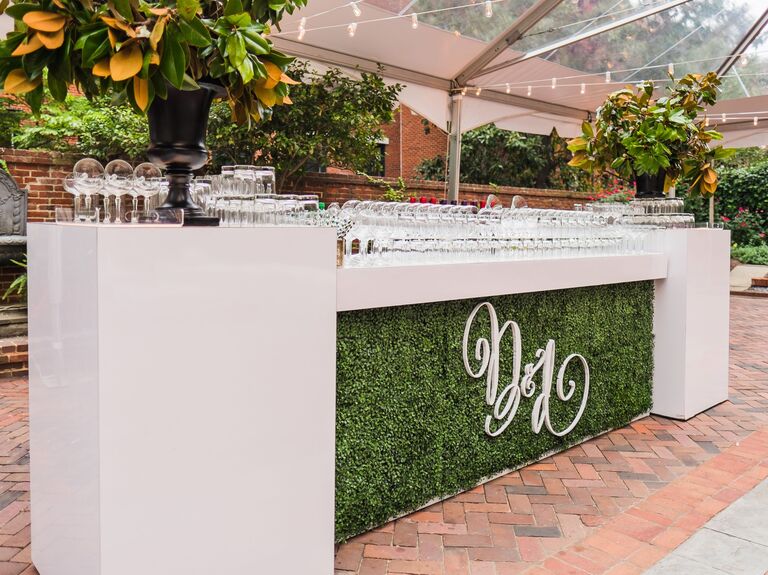 Boxwood paneled bar service with greenery and initials