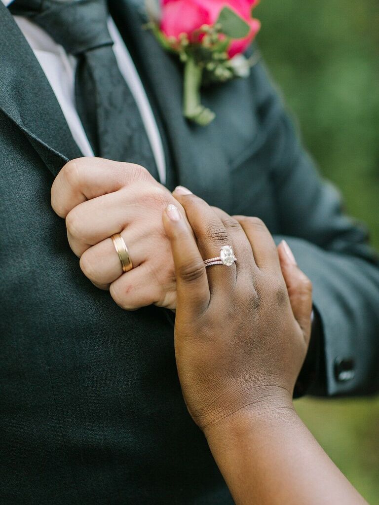 Bride and groom wearing wedding rings
