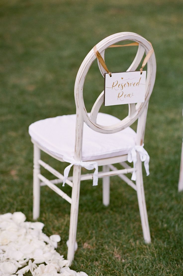 Simple white chair with reserved sign 